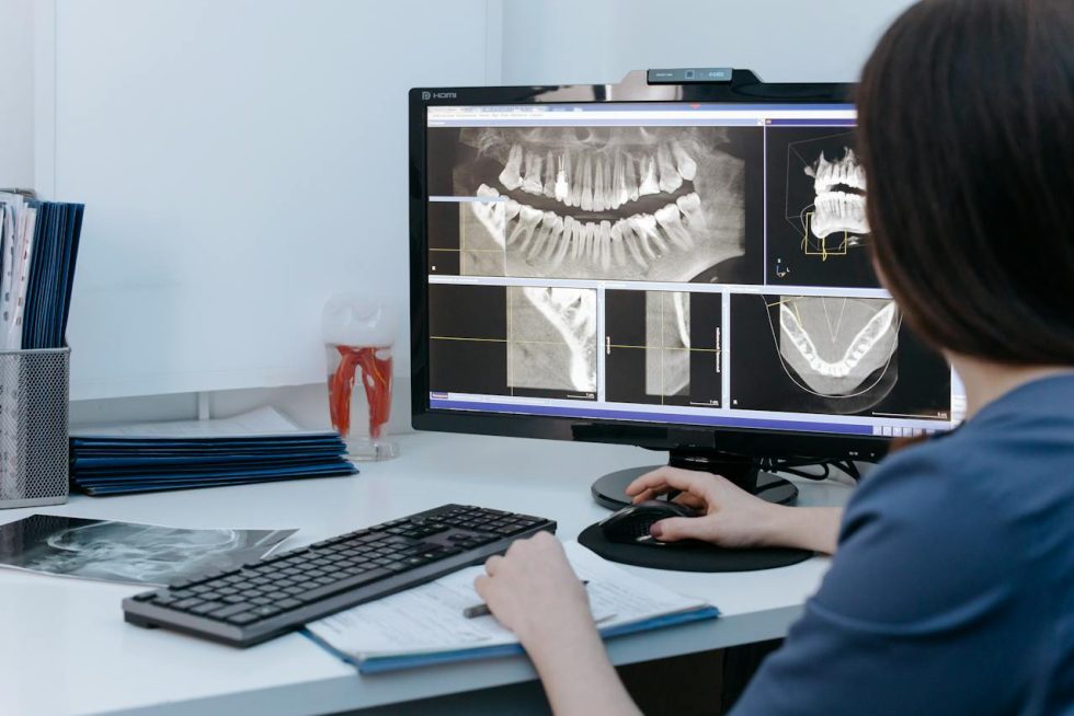 Dentist reviewing advanced 3D dental imaging